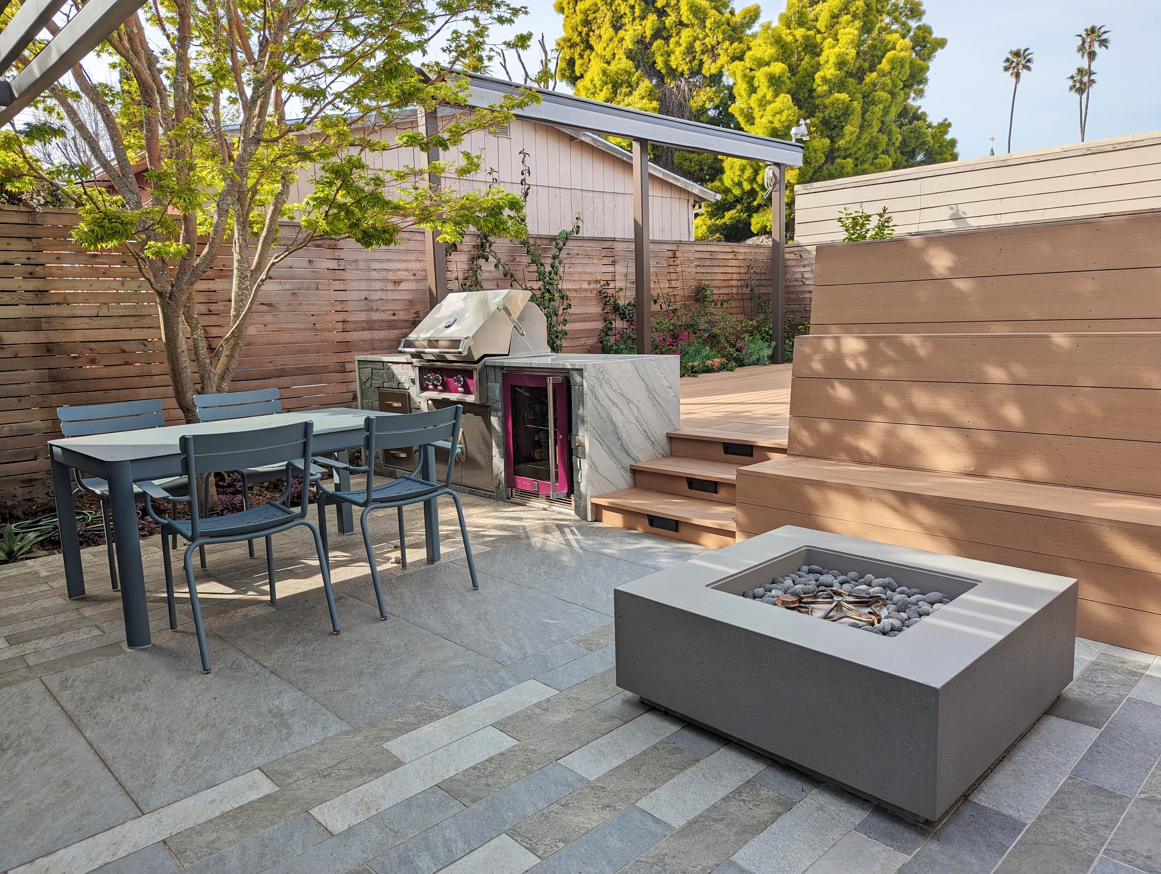 Porcelain paver, Composite deck, fire pit, outdoor kitchen, horizontal fence, step light, planter