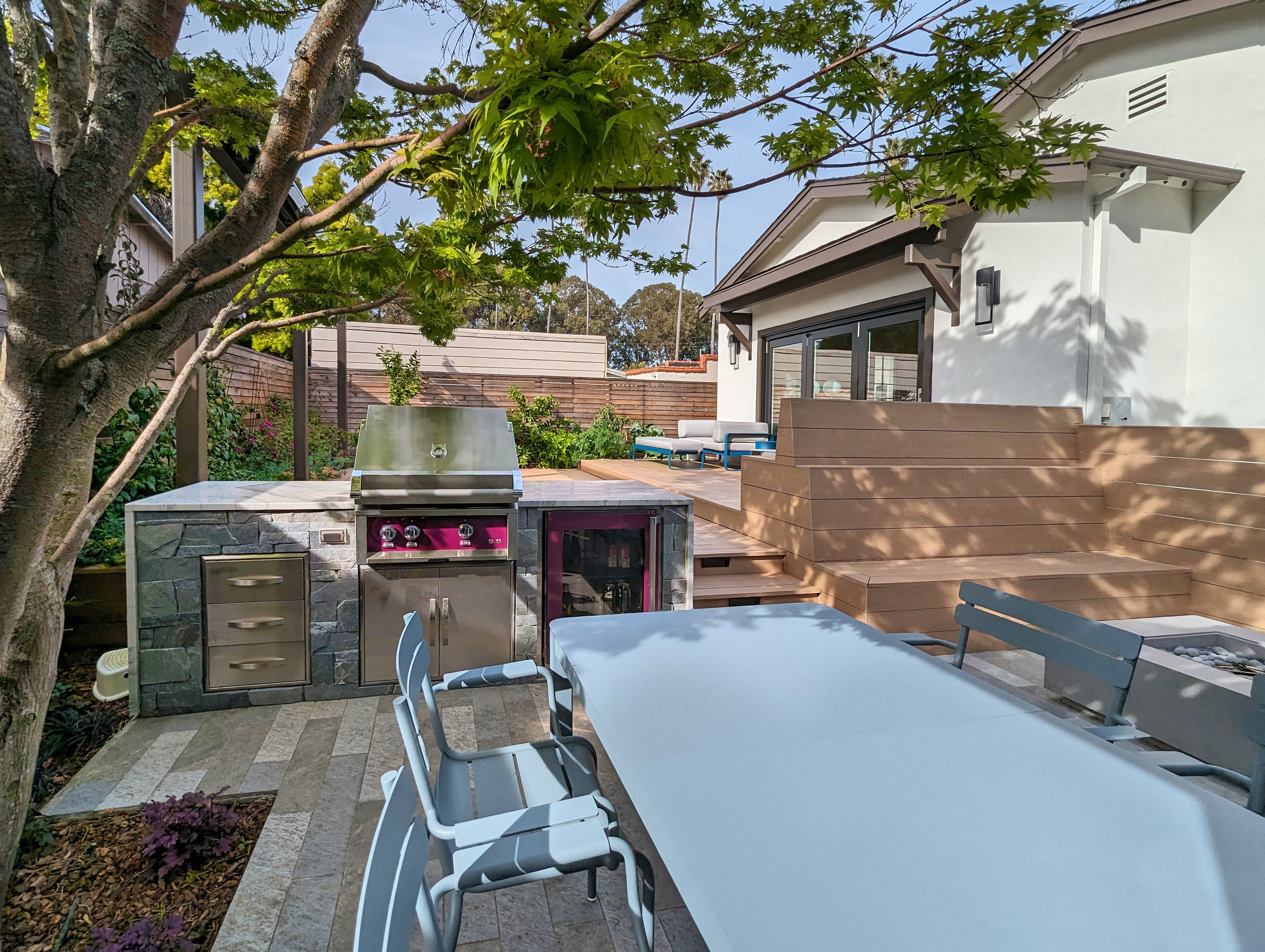 Porcelain paver, Composite deck, fire pit, outdoor kitchen, horizontal fence, step light, planter